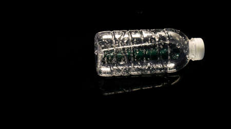 plastic water bottle floating on water on black background Can be easily used in projects. Plastic...