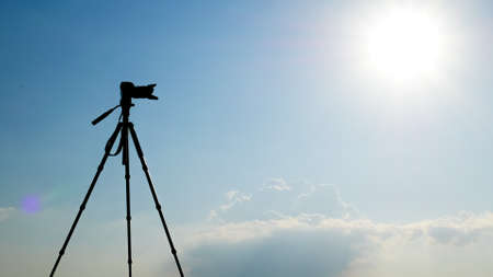 Silhouette Cameras are mounted on a tripod. on the mountain to photograph the sceneryの写真素材