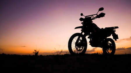 Silhouette of a dirt bike or motocross in the evening. travel and adventure conceptの写真素材