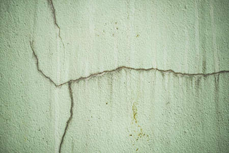 Cracked cement walls peeled off due to non-standard construction.