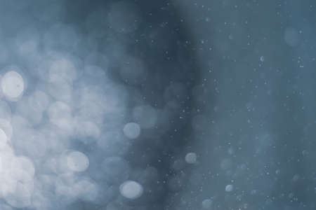 abstract colorful defocused circular facula,abstract background. Abstract background. Gray, white circles, lights on a black background. Blurry, out of focus image.の写真素材