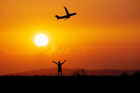 Cyclists wave to passenger planes in the beautiful evening. travel conceptの写真素材