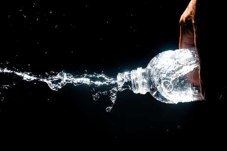 Scattered water splashes on a black background. Drinking water is refreshing.の写真素材