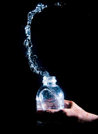 Scattered water splashes on a black background. Drinking water is refreshing.