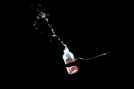 Scattered water splashes on a black background. Drinking water is refreshing.の写真素材