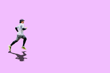 Asian man in white shirt is jogging on colored background with clipping path. Fitness and running concept.の写真素材