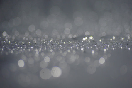 Abstract background of bokeh created by water droplets and blurred lenses.
