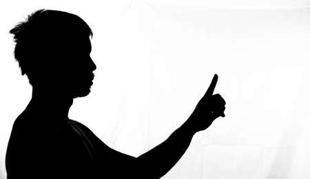 Side image half shadow of a man. silhouette of a man on a white backgroundの写真素材