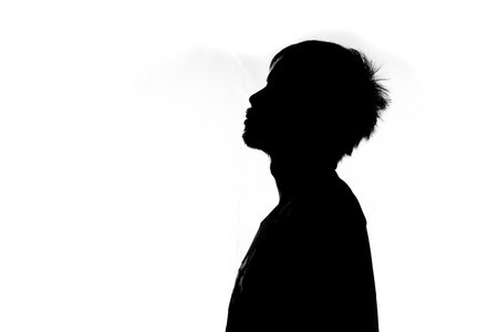 Side image half shadow of a man. silhouette of a man on a white backgroundの写真素材