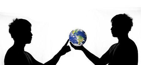 A half-shadow side view of a man holding a globe and staring. silhouette of a man on a white backgroundの写真素材