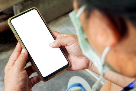 cell phone blank screen mockup. background empty space for advertise. Woman hand holding the black smartphone with blank screen and modern frameless design.の写真素材