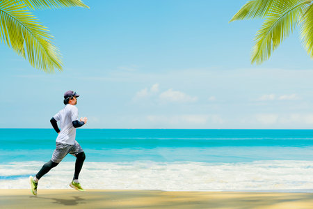 man jogging on the beach There is a beautiful sea view. running at the beachの写真素材