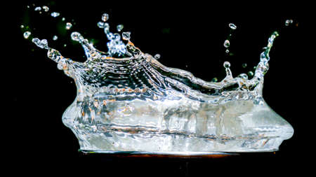 Scattered water on a black background. splashing water on black background for use in the projectの写真素材