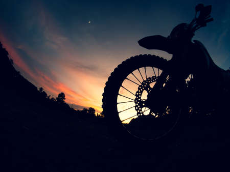 The silhouette of a motocross motorcycle in the evening is beautiful.の写真素材