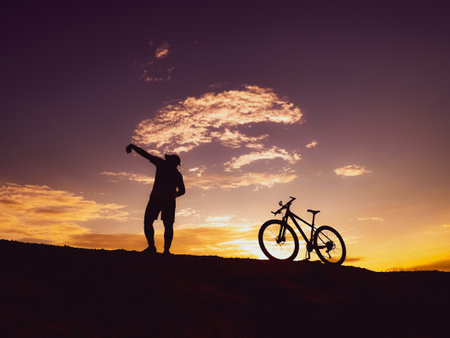 Man with a mountain bike on a beautiful day. happy men and bicyclesの写真素材