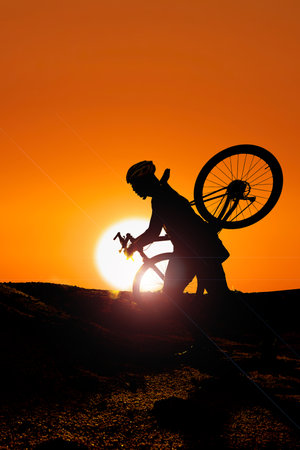 Bicycle adventurous tourists carrying bicycles over obstacles.の写真素材