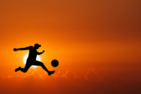 Silhouette of soccer players playing soccer in the evening. Fun concept of playing football.の写真素材