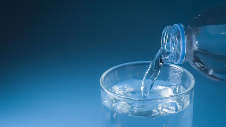 studio shot Clean drinking water poured into glass and natural blue background. healthy drinking water conceptの写真素材