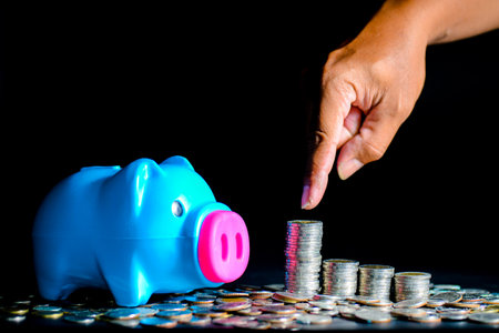 Piggy bank and lots of coins. money saving and money management conceptの写真素材