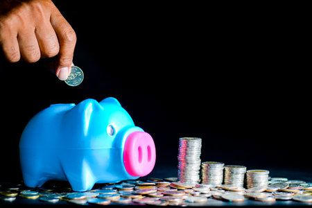 Piggy bank and lots of coins. money saving and money management conceptの写真素材