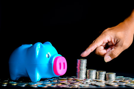 Piggy bank and lots of coins. money saving and money management conceptの写真素材