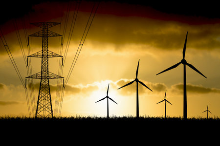 Wind turbines generate energy power electricity during the evening. The sun goes down. Silhouettes, wind turbines, clean energy in the eveningの写真素材