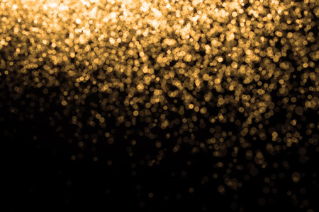 Golden background. Abstract gold background. Festive Golden Christmas Background.Background is glittering with golden light,bokeh defocused light.の写真素材