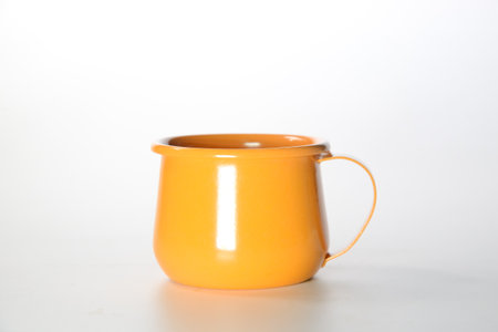 Zinc glass bright orange on a white background. Ideas for mock ups.

Blank mock up Empty classic undervest mug with neckline mockup, isolated.の写真素材