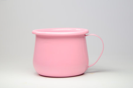 Bright pink zinc mug on white background. Blank mockup idea. A classic undervest empty cup.の写真素材