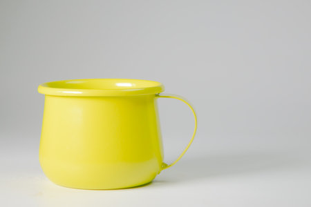 Bright green zinc mug on a white background. Blank mockup idea. A classic undervest empty cup.の写真素材