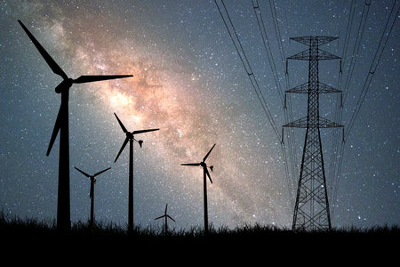 Wind turbine silhouettes are used to generate electricity in the fields during the evening hours.の写真素材
