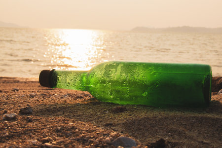 Trash bottles at the beach. garbage and pollution conceptの写真素材