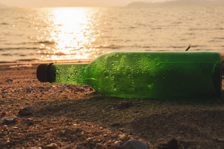Trash bottles at the beach. garbage and pollution conceptの写真素材