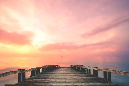 A wooden bridge jutting out into the sea with a beautiful view.の写真素材