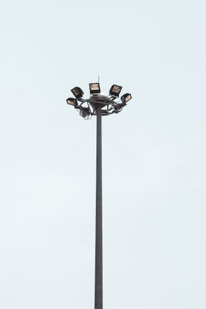 Electric poles and large spotlights provide light. on a white backgroundの写真素材