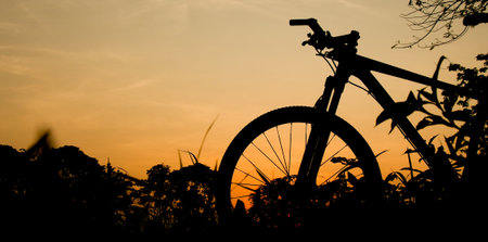 Silhouette of a mountain bike in the evening. fitness and adventure ideasの写真素材