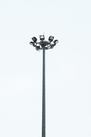 Electric poles and large spotlights provide light. on a white backgroundの写真素材