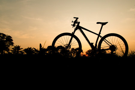 Silhouette of a mountain bike in the evening. fitness and adventure ideasの写真素材