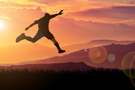The silhouette of a man is jumping forward. The concept of clawing through hurdles