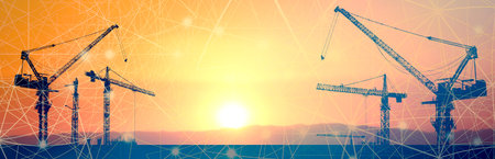 Crane concept in the construction industry. The silhouette of the crane in the construction siteの写真素材