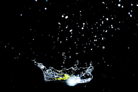 Scattered water splashes on a black background. water splash isolated on the black backgroundの写真素材