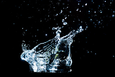 Scattered water splashes on a black background. water splash isolated on the black backgroundの写真素材
