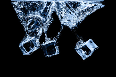 Ice cubes in water on studio dark background. The concept of freshness with coolness from ice cubes.の写真素材