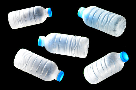Plastic bottles of water isolated on black backgroundの写真素材