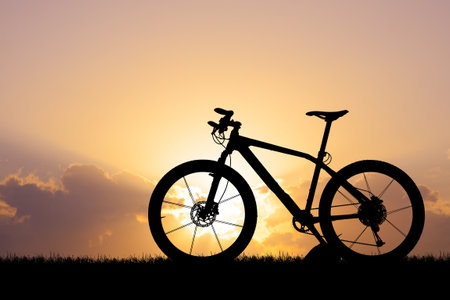 silhouette of mountain bike on sunset sky backgroundの写真素材