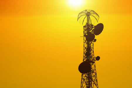 Silhouette of the radio tower against the sun at sunset.の写真素材