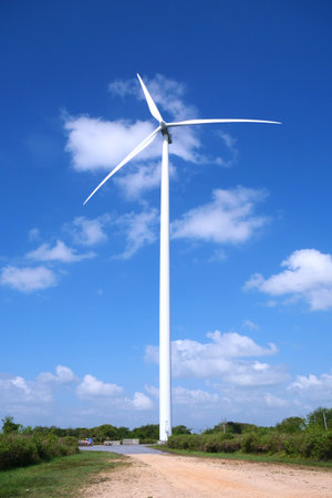 Wind turbine on blue sky background. Alternative energy source for electric power.の写真素材