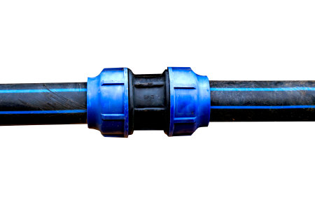 High-resolution image of an industrial pipe connector with blue fittings on a black pipe, isolated on a white background with clipping path.の写真素材
