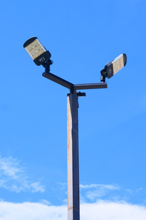 A contemporary street light set against a vibrant blue sky, showcasing minimalist urban design and efficient lighting.の写真素材
