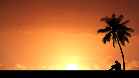 A serene silhouette of a person sitting by a palm tree during a stunning orange sunset on a tropical beach.の写真素材